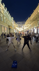 Street performers draw crowds on illuminated Moscow pedestrian walkway