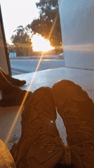 Two pairs of shoes spotted in truck during highway sunset