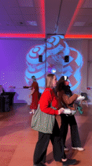 Indoor venue gathering documented in Bydgoszcz with colorful lighting