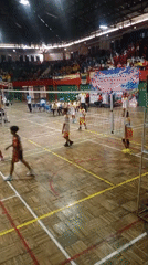 Volleyball match and street vendors at GOR Wuryorejo, Indonesia