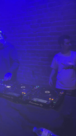 Pioneer DJ setup glowing in a brick-walled Saint Petersburg venue