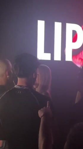 Inside a Milan nightclub lit by neon and colored lights