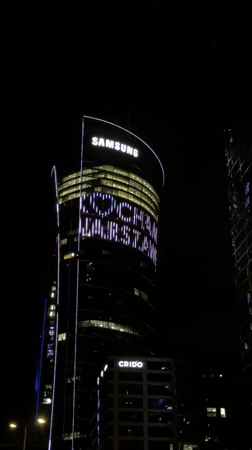 Samsung-branded Warsaw skyscraper glowing after dark