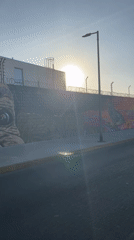 Street mural with eye, nature themes documented in Arica