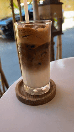Layered Vietnamese iced coffee on a café table in Đà Nẵng