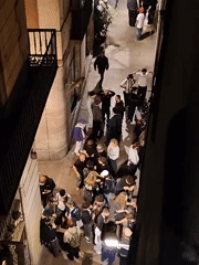 Young adults gather in Barcelona's narrow streets at night