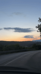 Dashboard camera captures dusk drive through Montenegro hills