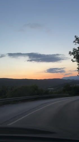 Dashboard camera captures dusk drive through Montenegro hills