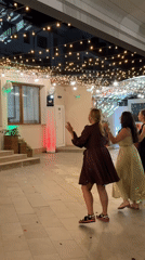 Wedding circle dance under golden lights in Bistritsa