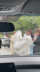 Wedding party assists bride during rainy day in Sochi
