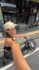 Tourist documents art installations while cycling through Tegallalang