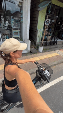 Tourist documents art installations while cycling through Tegallalang