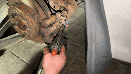 Mechanic uses torch on rusted brake caliper in Hrodna garage