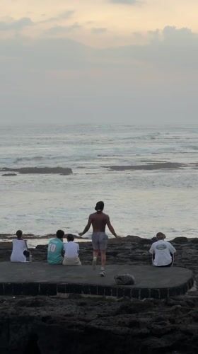Bali shoreline moments: group gathering and beachside training