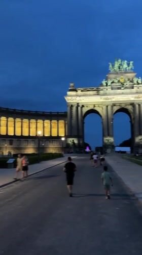Brussels' Cinquantenaire arch lit up at dusk