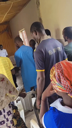 Community meeting held in Madalla, Nigeria with speaker and attendees