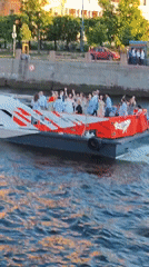 Passenger catamaran crosses Saint Petersburg river during sunset
