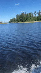 Recreational boating documented on Russian lake under clear skies