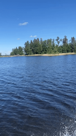 Recreational boating documented on Russian lake under clear skies