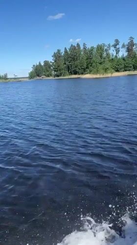 Recreational boating documented on Russian lake under clear skies