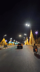Night scenes with holiday lights, woman at gas station in Vietnam