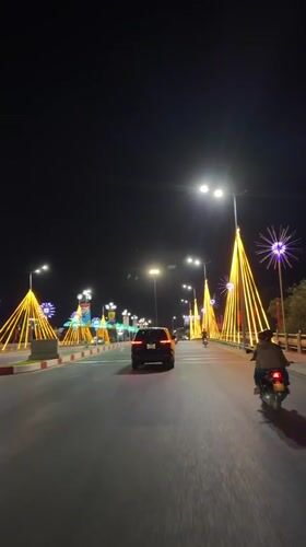 Night scenes with holiday lights, woman at gas station in Vietnam