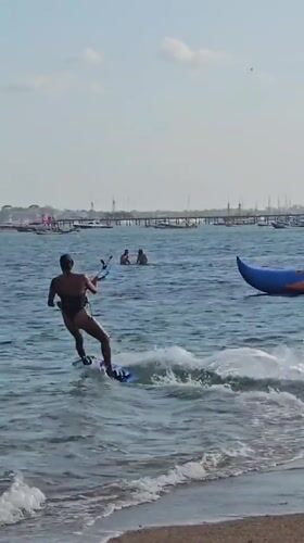 Kitesurfing session off the Bali coast on a clear morning