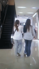 Two women walk through shopping mall in Iran