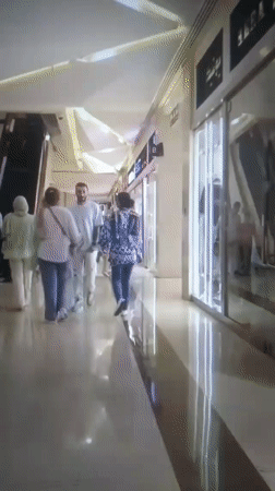 Two women walk through shopping mall in Iran