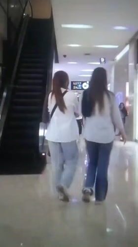 Two women walk through shopping mall in Iran