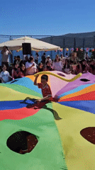 Community celebration with parachute games held in Bijela, Montenegro