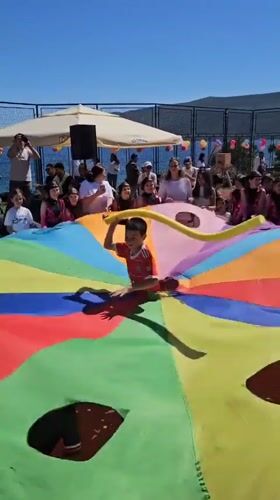 Community celebration with parachute games held in Bijela, Montenegro