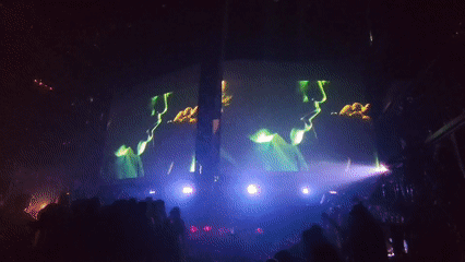 Video of blonde singer with microphone displayed on screens