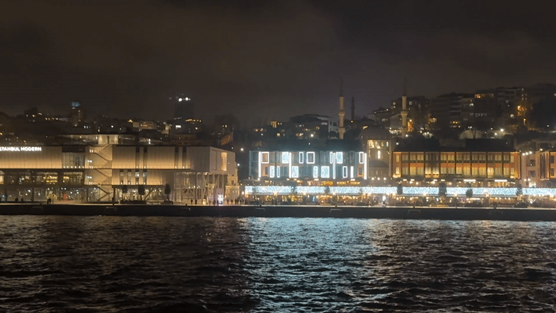 Evening waterfront activity captured near Istanbul Modern building