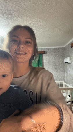 Woman and boy share dancing moment in Foki, Russia