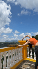 Yoga poses on a Da Lat balcony overlooking green hills