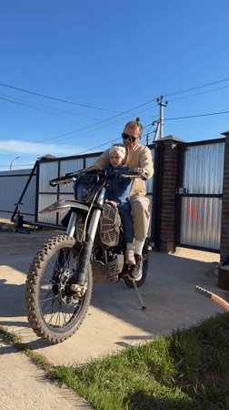 Father and child enjoy dirt bike ride in Prikamskii