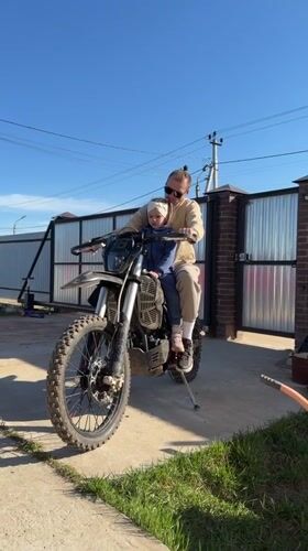 Father and child enjoy dirt bike ride in Prikamskii
