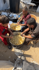 Outdoor communal cooking underway at a Gaza camp