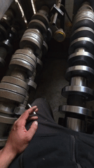 Person smokes among camshafts in Bulgarian village