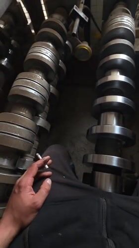 Person smokes among camshafts in Bulgarian village