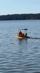 Person paddles yellow boat on lake in Votkinsk Russia