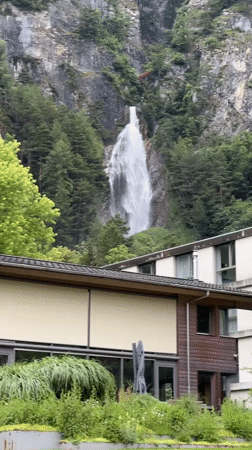 Tourist documents waterfall hike in Swiss mountain village