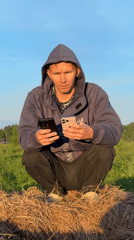 Two people gather in rural Russian field during golden hour