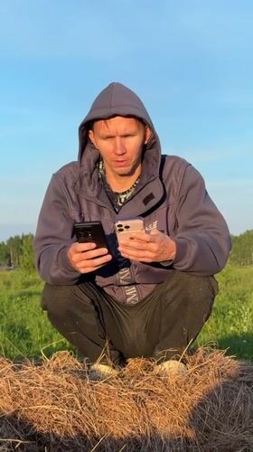 Two people gather in rural Russian field during golden hour