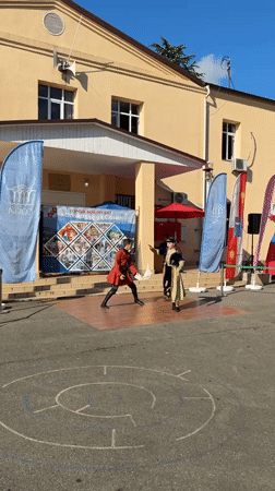 Community street festival with folk performances and vendor stalls in Progress
