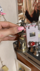 Person demonstrates souvenir bell collection in Izhevsk apartment