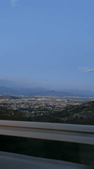 Night city lights captured from elevated roadside in Montenegro