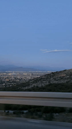 Night city lights captured from elevated roadside in Montenegro