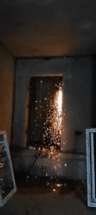 Metal grate getting cut with a grinder, sparks flying